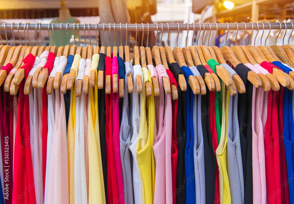 Colorful clothes fashion hang on a shelf at flea market shopping