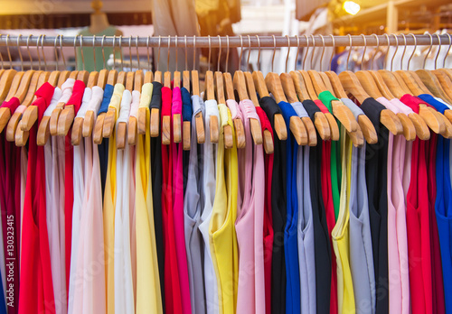 Colorful clothes fashion hang on a shelf at flea market shopping
