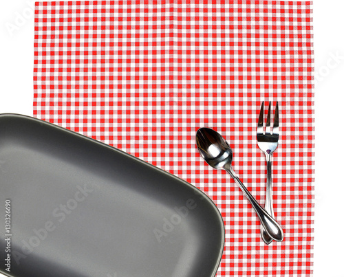 Top view plate with fork and spoon on tablecloth for food servin photo