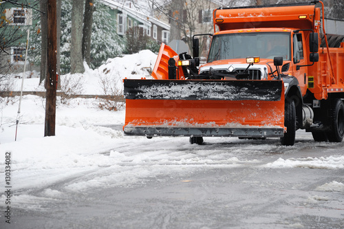 snowplow removing snow in the street after blizzard