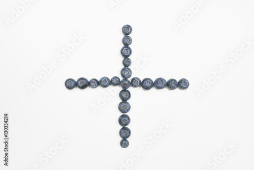 Blueberries in cross shape with white background