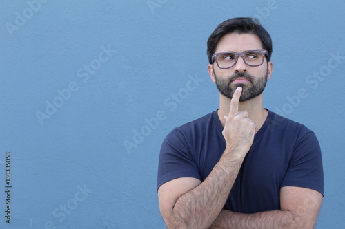Young handsome man doubting isolated over blue background with lots of copy space 