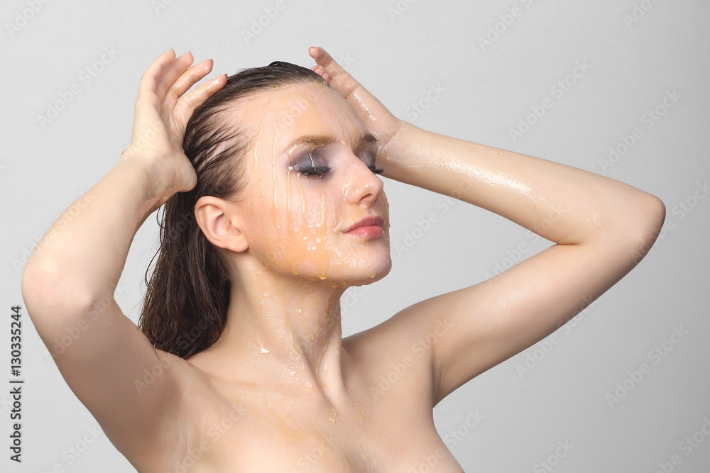 Beautiful woman with honey on her face