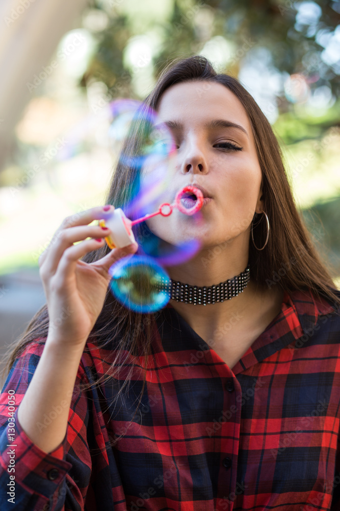 Young girl blowing soap bubbles Young girl blowing soap bubbles