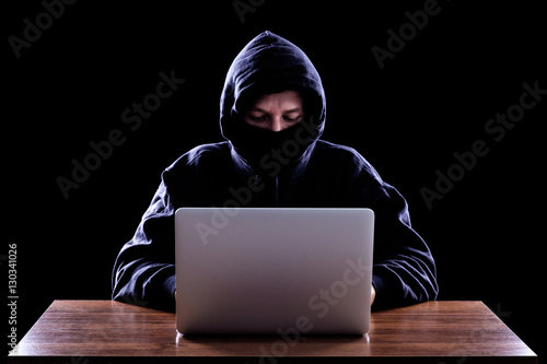 Computer hacker stealing data from laptop