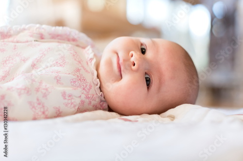 Baby girl lying on her blanket