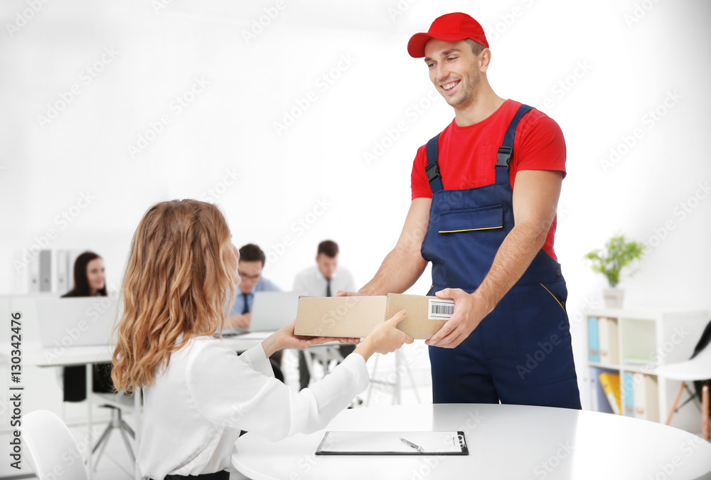 Courier delivering package in office