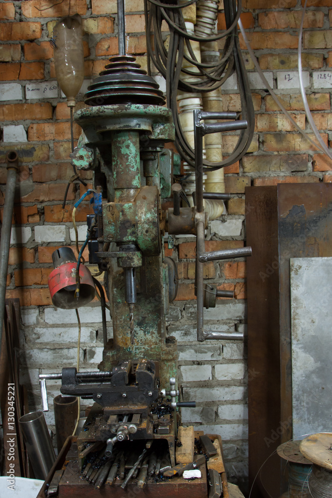 Old and dirty drilling machine in factory