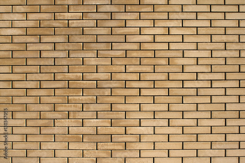 High resolution texture of a yellow brick wall. Laying horizonta