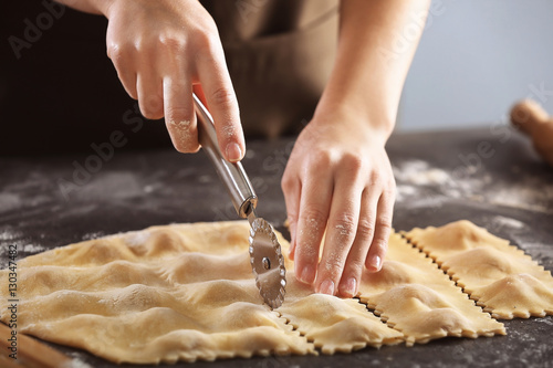 Bild auf Leinwand Woman making ravioli on table