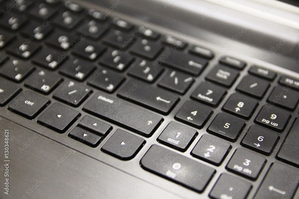 The black keyboard of the mobile computer with white letters The black keyboard of the mobile computer with white letters