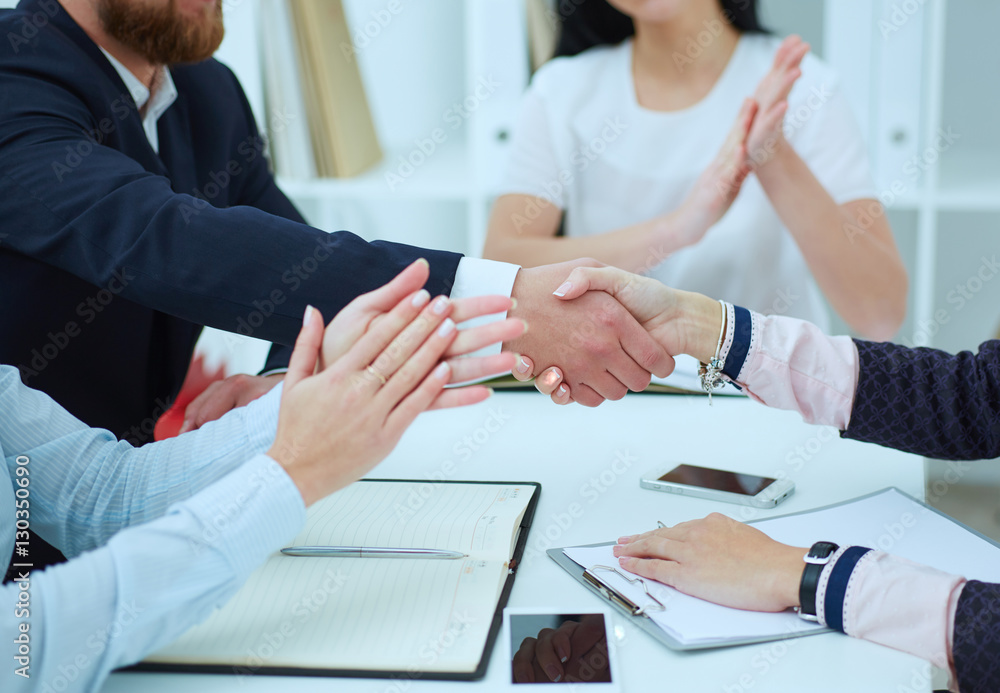 Male and female handshake in office. Serious business and partnership concept. Partners made deal, sealed with handclasp. Male and female handshake in office. Serious business and partnership concept. Partners made deal, sealed with handclasp.