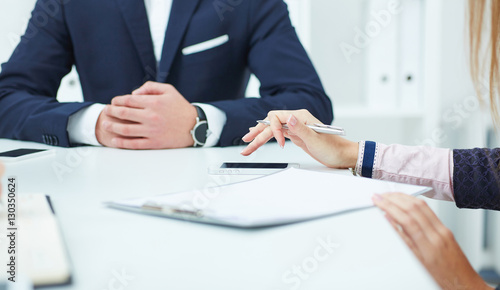 Girl using a mobile phone during a business meeting