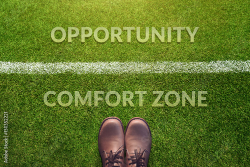Top view, Male with Leather Shoes with a word : Comfort Zone and Opportunity between a line on Green Grass Field, Making Decision in Life photo