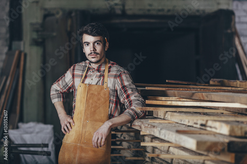 Portrait of carpenter standing in workshop photo