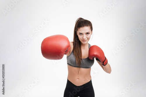 Young fitness woman punching the camera with boxing gloves © Drobot Dean