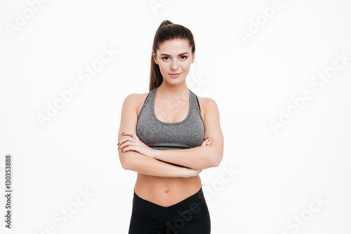 Sports woman standing with arms folded and looking at camera