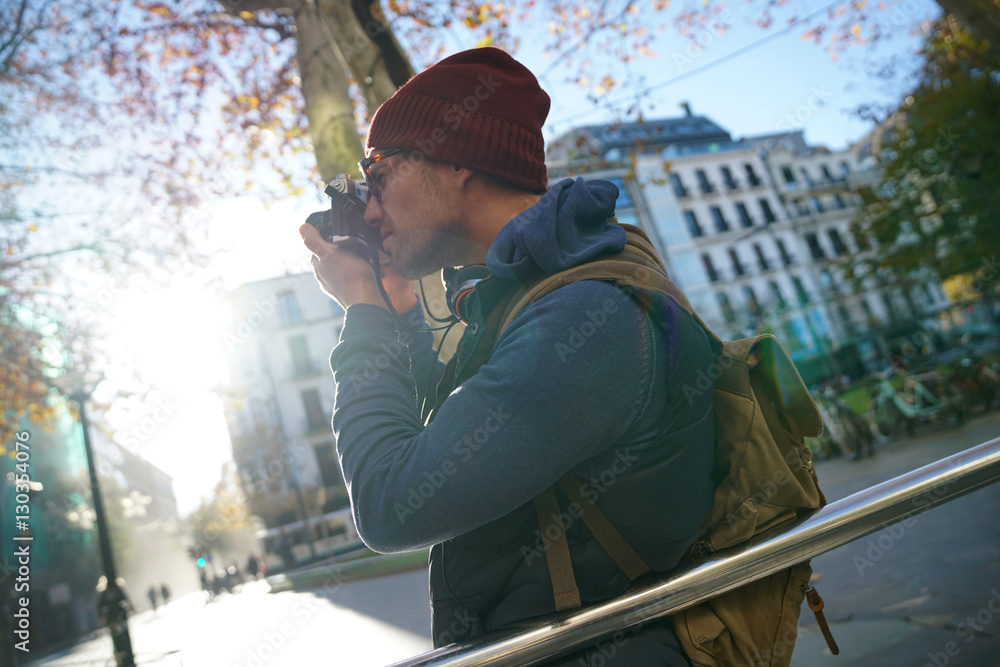 Hipster guy taking pictures in town Hipster guy taking pictures in town