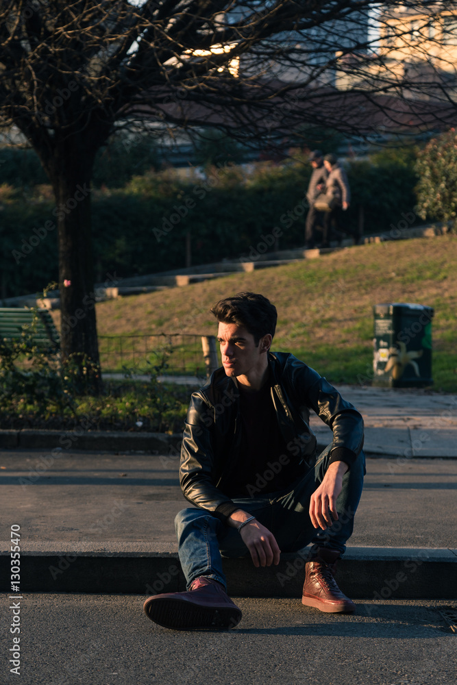 Fototapeta premium Beautiful young man posing in an urban context