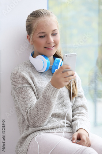 Cute teenager with headphon...