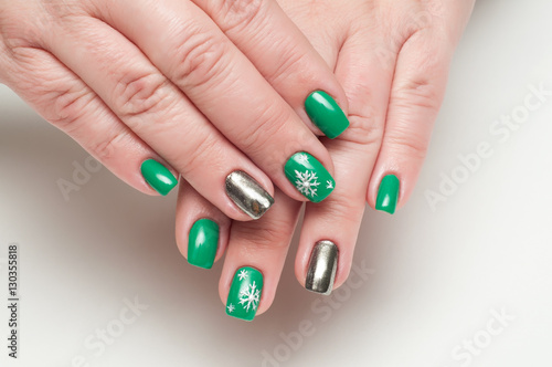 Winter Christmas green manicure  with silver snowflakes