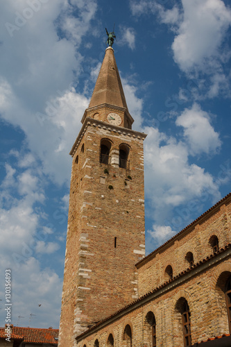 Clock tower of the Romanesque church in the center of Grado