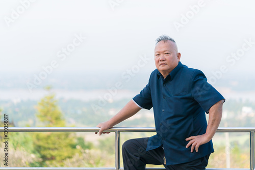 Happy 60 year old senior asian man with arm akimbo and standing on nature view background with copy space
(With hands on the hips and elbows turned outwards)