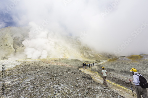 Visitors at an active andesite stratovolcano on White Island, North Island, New Zealand photo