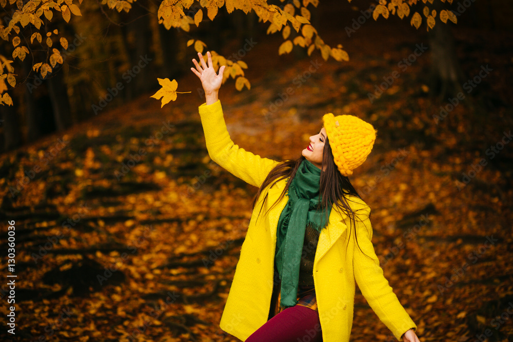 Fototapeta premium beautiful young woman walking outdoors in autumn