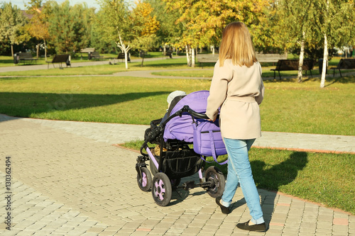 Woman with baby stroller wa...