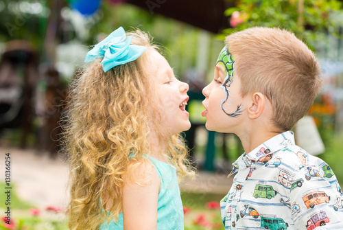 The boy and girl child with aqua make-up on happy birthday. Celebration concept and childhood, love