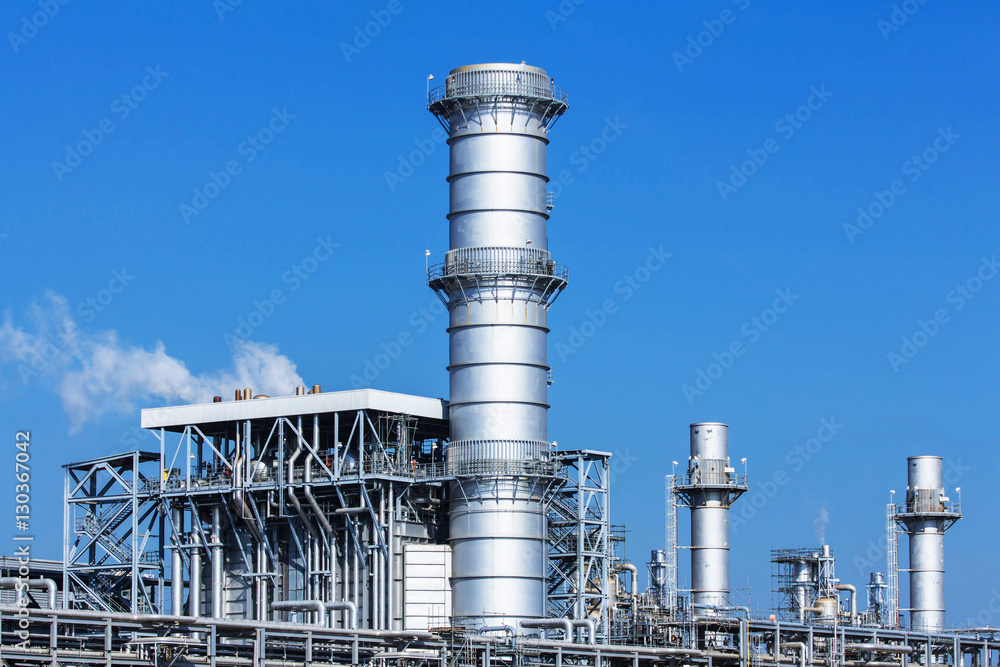Refinery tower in petrochemical industrial plant with cloudy sky