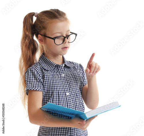 Cute little girl reading bo...