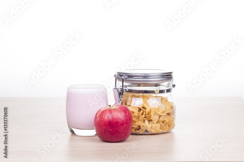 breakfast with cereal, milk and apple

