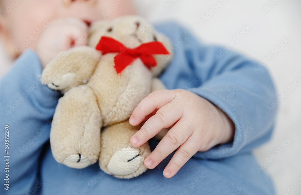 Teddy bear in baby hand. Hand of baby holding toy. Teddy bear in baby hand. Hand of baby holding toy.