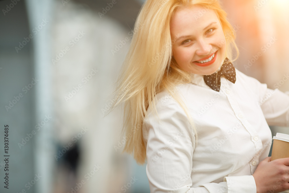 Happy smiling young blond woman in white shirt with tie Happy smiling young blond woman in white shirt with tie