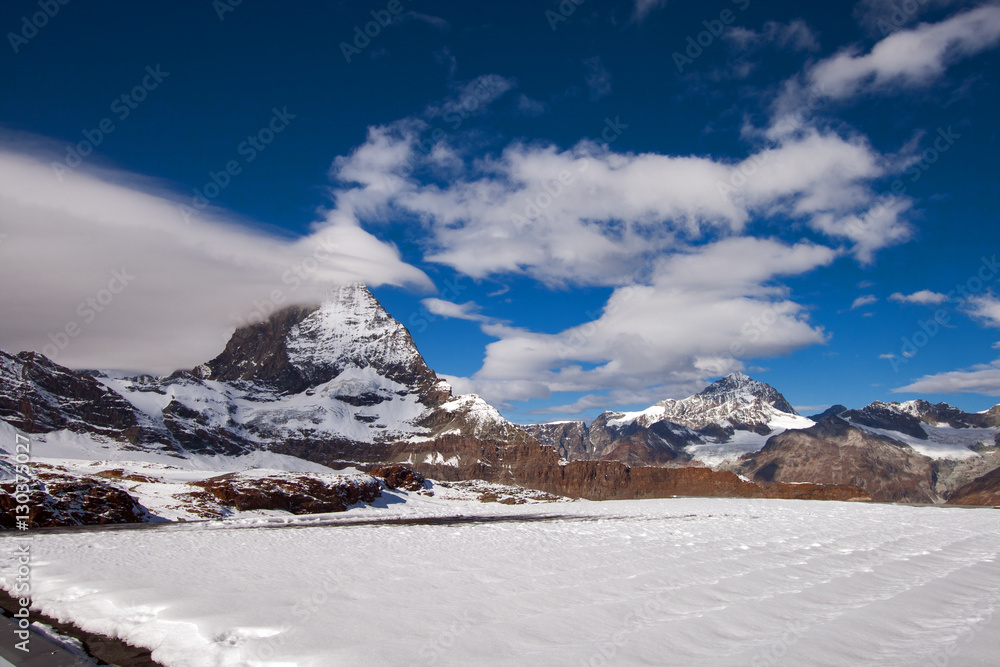 Obraz premium Matterhorn covered with clouds on a clear day after snow fall in autumn, Valais, Switzerland