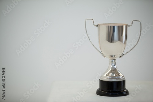 Silver trophy on grey background