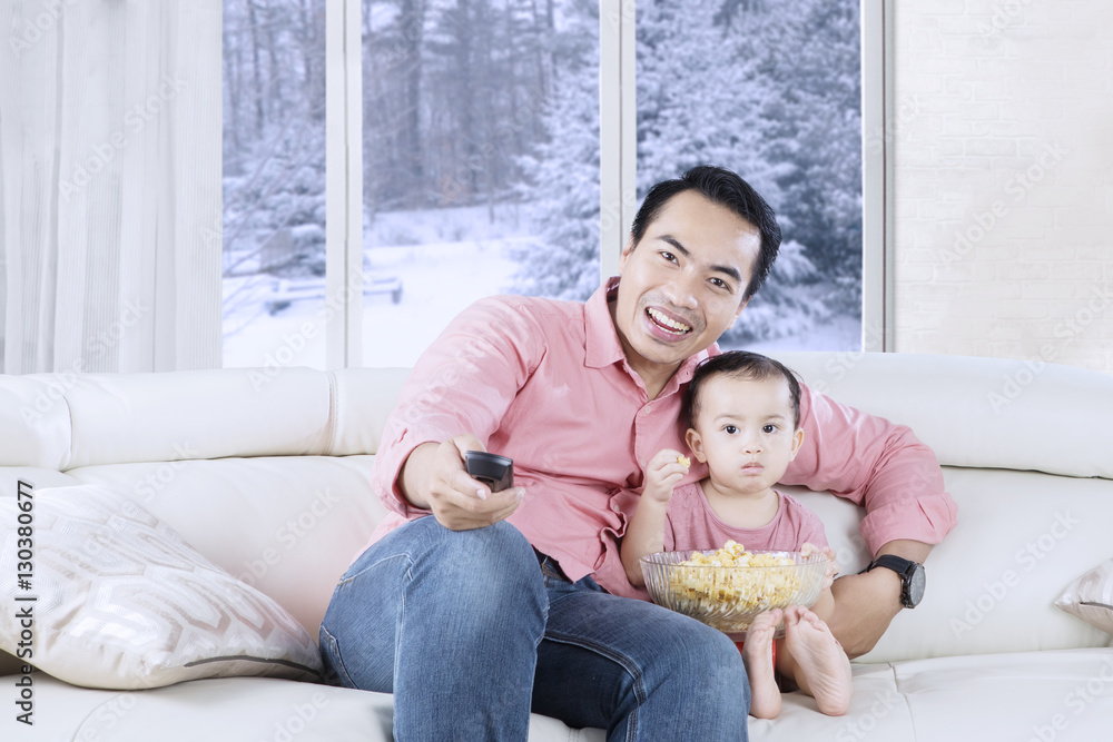 Fototapeta premium Happy father holds remote control