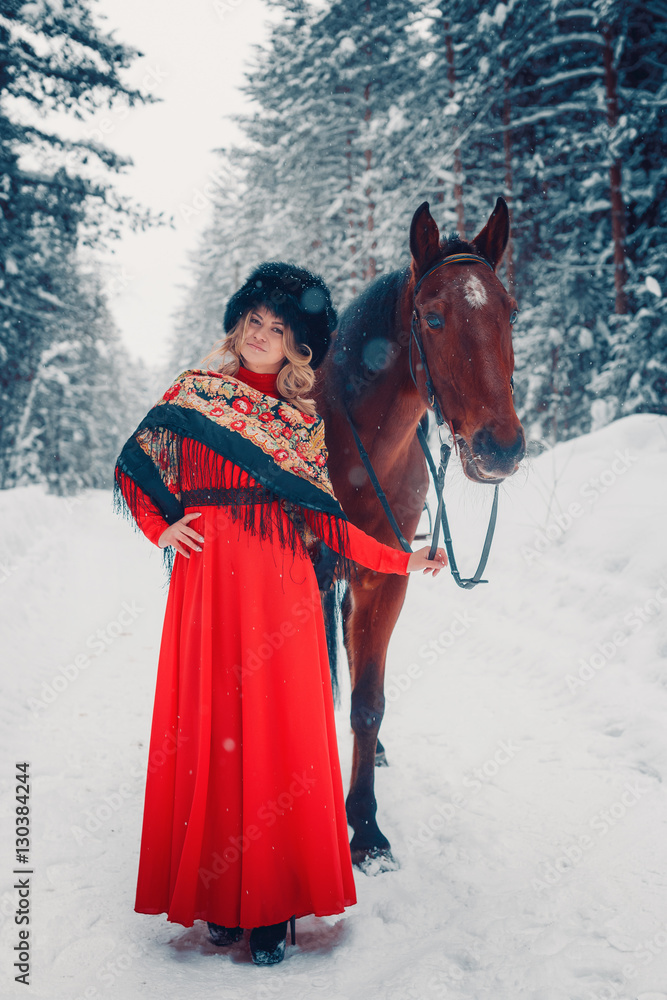 Fototapeta premium Photo Full-length of a beautiful girl and handsome stallion, horse in the winter on the nature