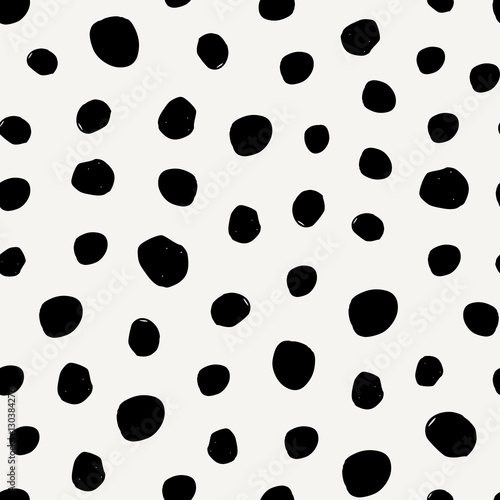Seamless pattern with irregular dots in black on cream background. photo