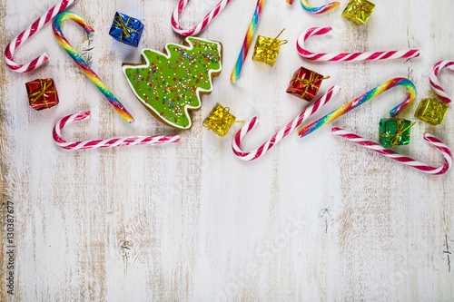 Gingerbread and candy canes on a wooden background. Christmas s