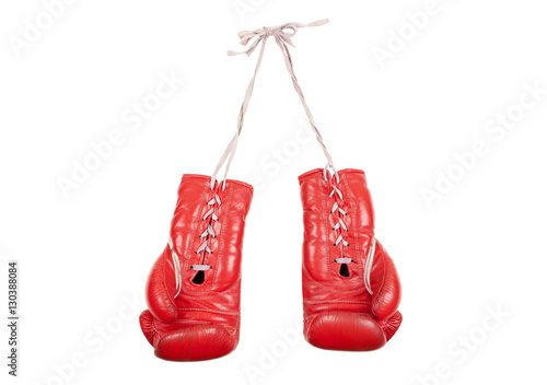 old used and battered red leather boxing gloves isolated on white background © monicaclick