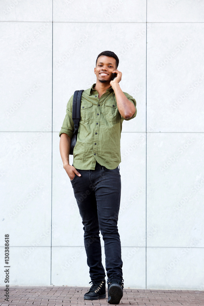 young college student on phone call with backpack young college student on phone call with backpack