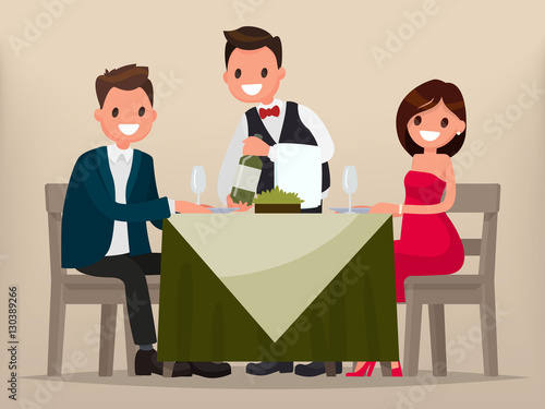 Young couple having dinner in a restaurant. Man and woman sittin