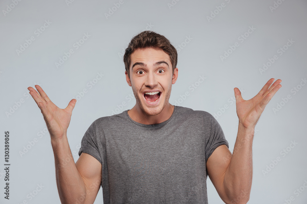Man standing with raised hands and looking at camera Man standing with raised hands and looking at camera