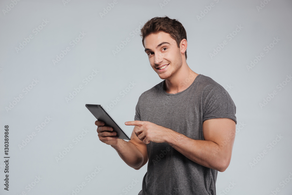 Portrait of a happy casual man using tablet computer Portrait of a happy casual man using tablet computer