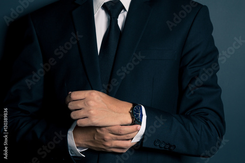 Businessman Fixing Cufflinks his Suit