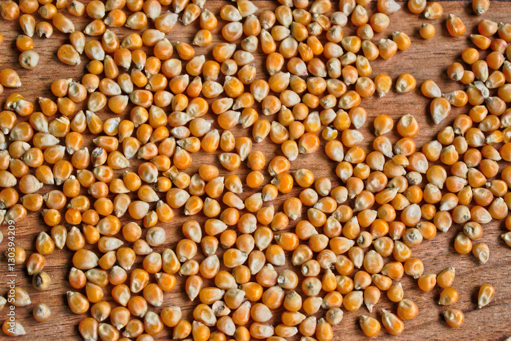 Popcorn kernels on a wooden table Popcorn kernels on a wooden table