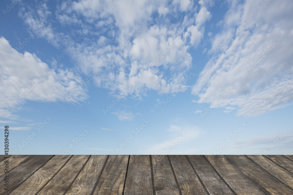 Wooden table on Blue sky background.